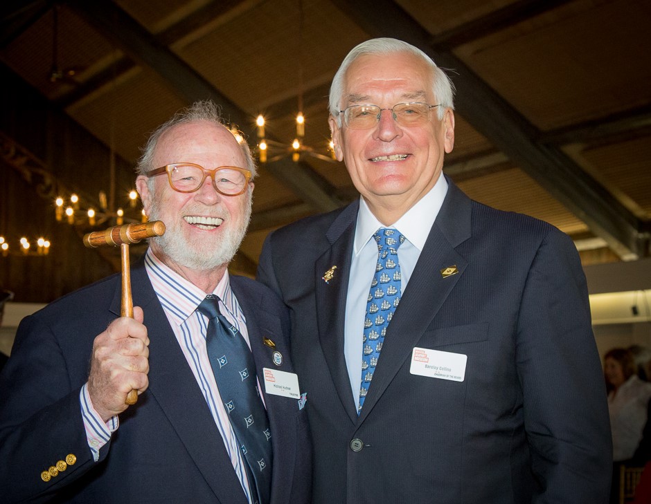Museum Chairman Michael S. Hudner, left, wields the chairman's gavel he just received from the outgoing chair, J. Barclay Collins, II, right.