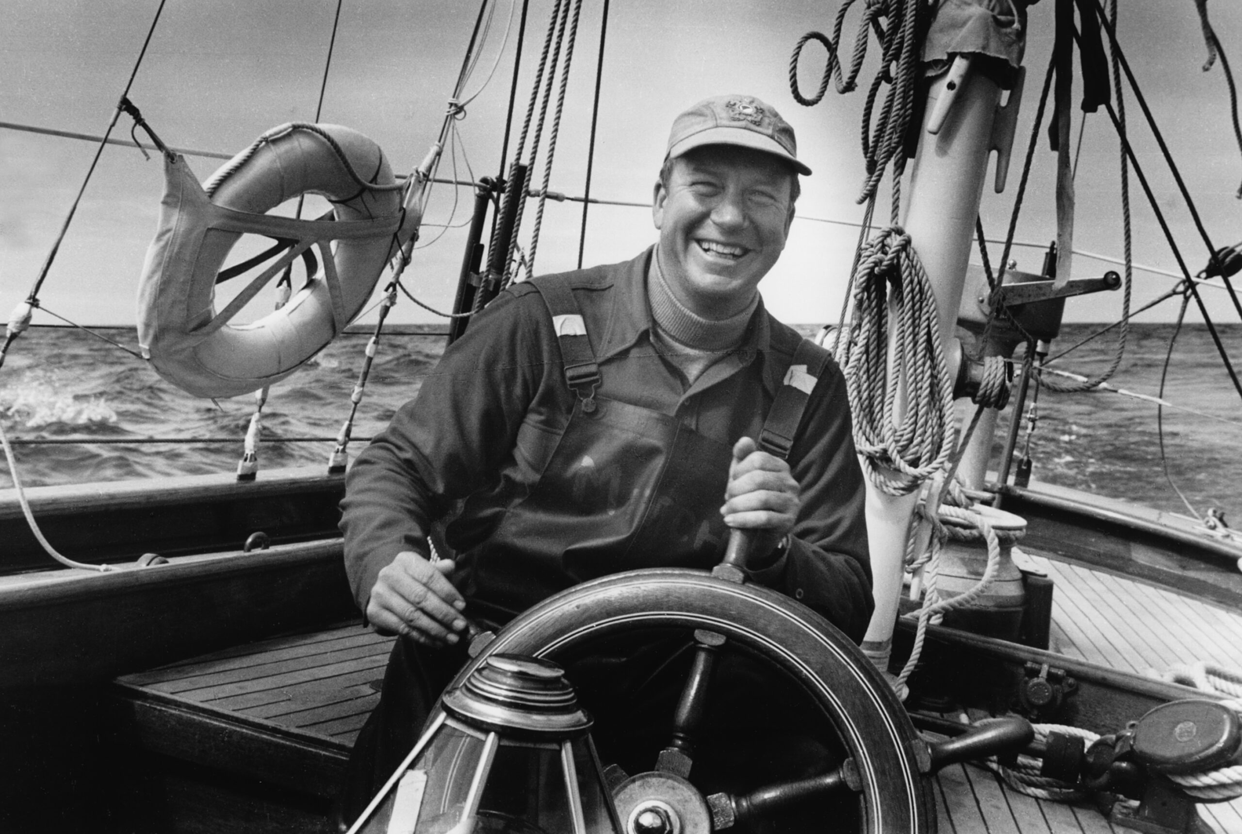 Carleton Mitchell at the helm of yawl yacht Carribbee while under sail during the Transatlantic Race from Bermuda to Plymouth, England, July 1952. Mystic Seaport Museum, Carleton Mitchell Collection, 1996.31.5388.14